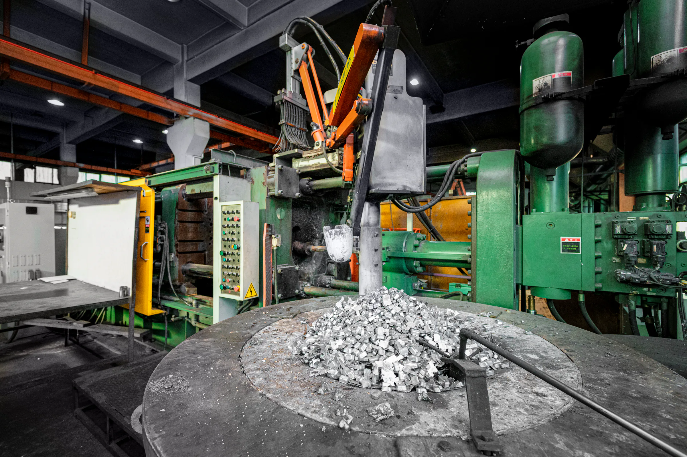 Die-casting production cell with metal process material in the foreground